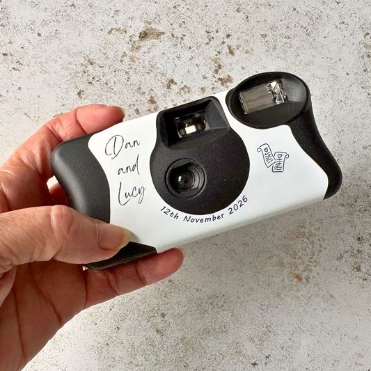 Minimalist line art wedding disposable camera wrap on a Kodak FunSaver, personalised with couple’s names and wedding date, featuring delicate black sketch illustrations on a white vinyl cover.