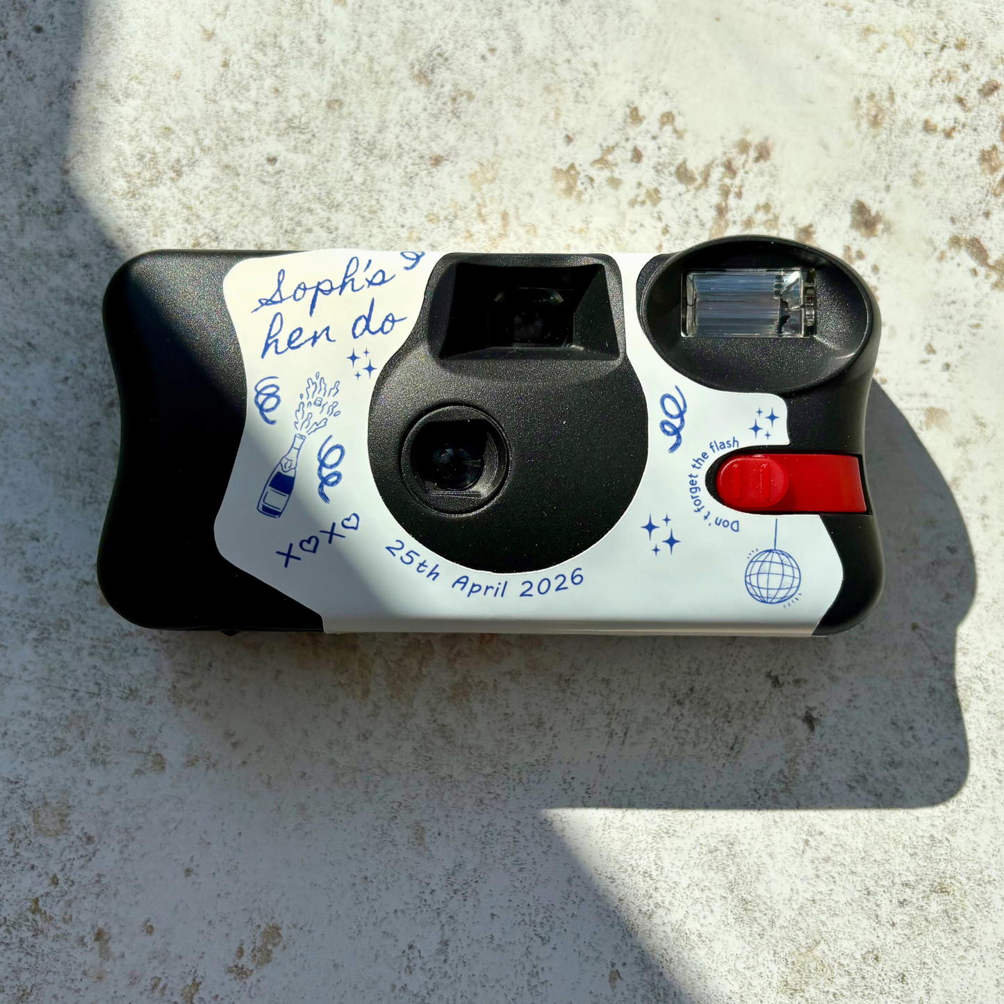  Disposable Kodak FunSaver camera with personalised hen party text and line art images on a concrete surface
