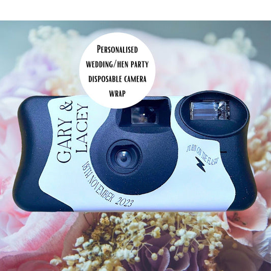 KodakFunSaver disposable camera replacement personalised sticker for your wedding.  Shown on a beach with a rock and a little plant in the foreground and the sea in the background.