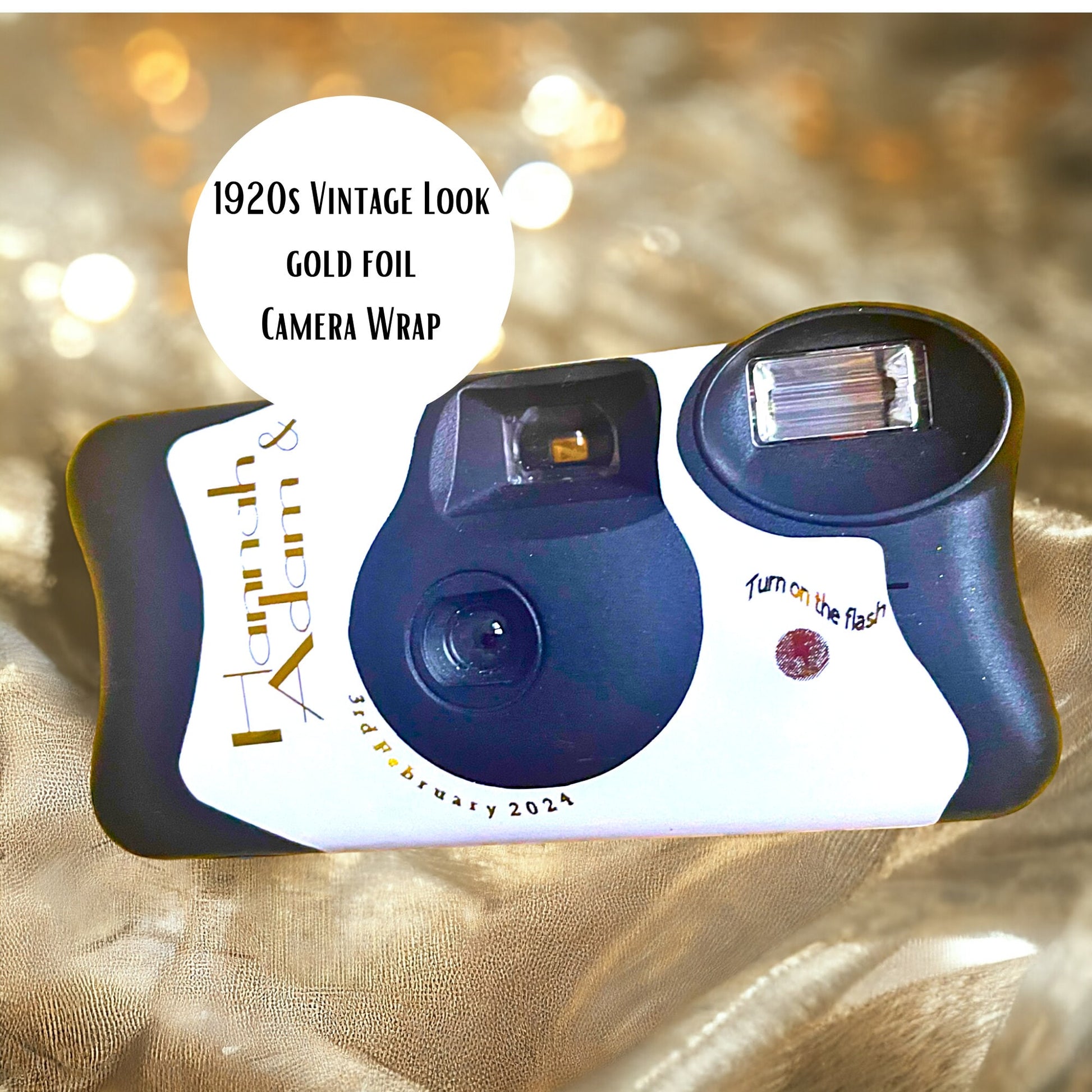 1920s Great Gatsby theme gold foil Kodak FunSaver disposable wedding camera stickers.  Personalised on the front and the reverse with your names and the date of your wedding. Pictured on a background of straw.